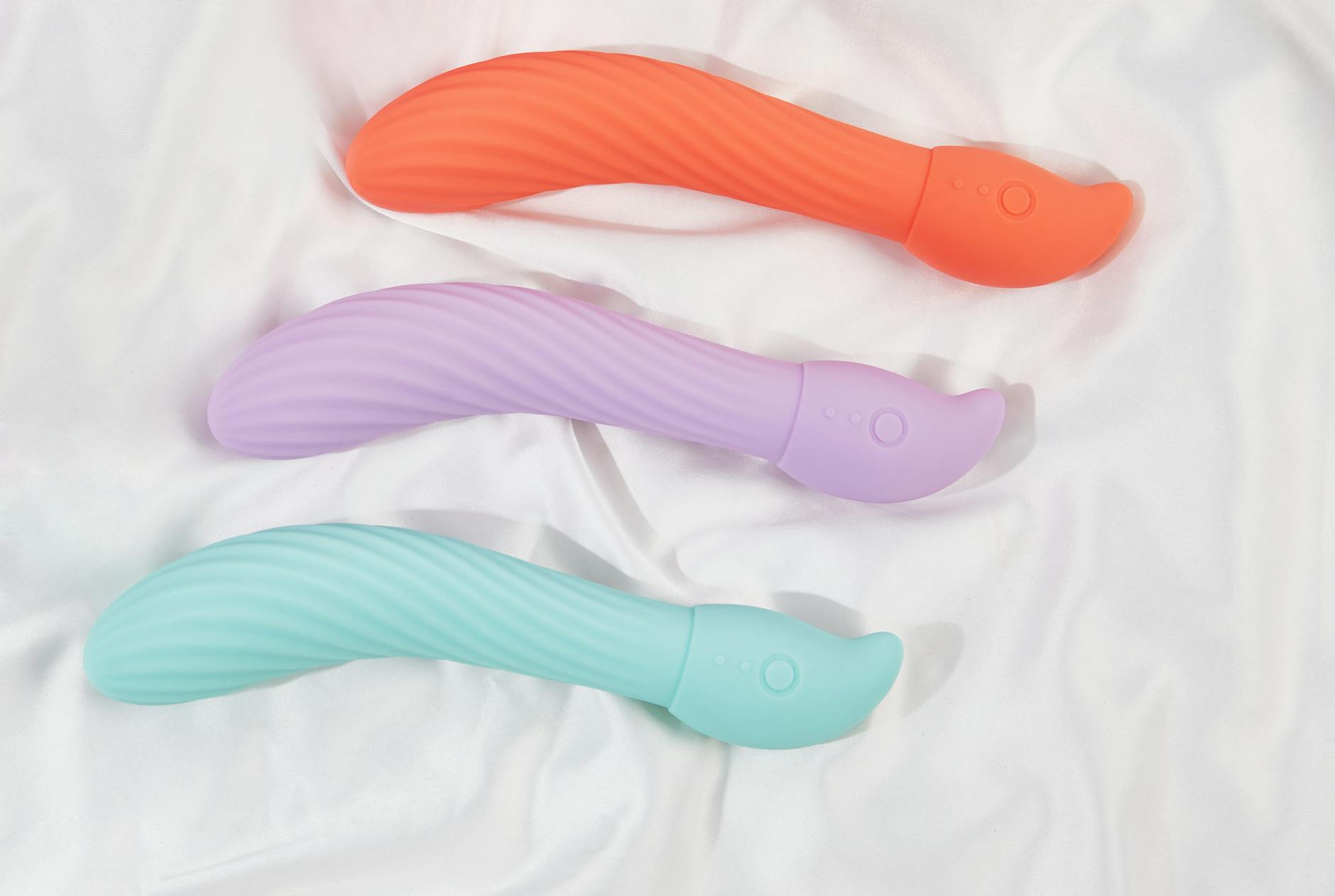 Three colorful lemon vibrators arranged on white fabric, showing varied textures and design